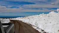 There is no longer snow ON the road thanks to road crews, but there may still be snow BY the road at higher elevations. BLM photo