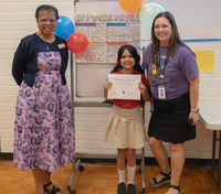 Mayor Denyse McGriff (left) presents Fifth Grader Brittney Gil-Rosales her award for placing second in the Oregon Mayors Association 