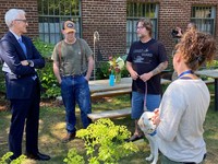 (Left to right) U.S. Department of Veterans Affairs Secretary Denis McDonough meets with Portland area Veterans, Brad Kuhn and Matt Rollins, while Mandi Adkinson, Therapeutic Garden Coordinator for the VA Portland Health Care System's VA FARMS conducts a tour of the garden.