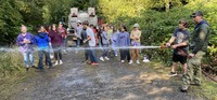 Michael Berger, an ODF seasonal wildland firefighter, give hands-on experience to sixth graders on using a wildland fire hose.  Typically, these hoses are smaller in diameter than structural fire hoses but operate the same way.