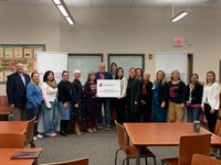 Teachers from Franklin STEM elementary and leadership from WSU Tri-Cities, and the Pasco School District and stand with the sign identifying Franklin Elementary as a WSU Tri-Cities College of Education Laboratory School.