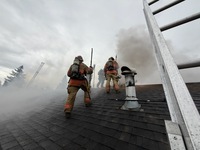 Firefighters working on Roof